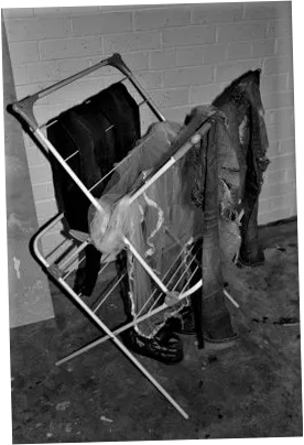 A black and white photograph of a clothes horse with Ana Hine's "most anarchist clothes" hanging on it
